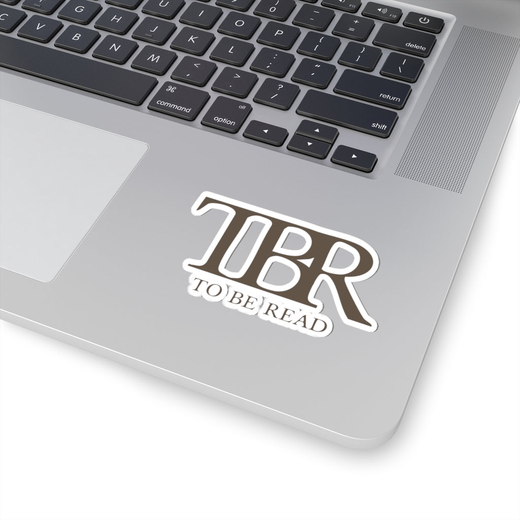 Thtgrlreads TBR sticker with bold, serif font reading "To Be Read," part of the Book Bestie and Off Brand collections, shown on a laptop surface.