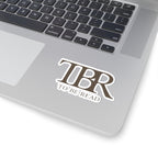 Thtgrlreads TBR sticker with bold, serif font reading "To Be Read," part of the Book Bestie and Off Brand collections, shown on a laptop surface.