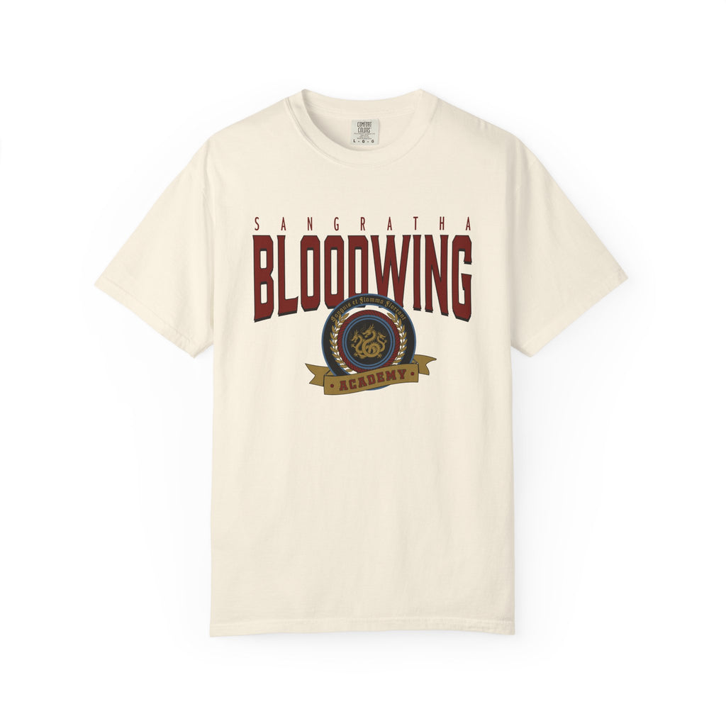 Officially licensed Bloodwing Academy Comfort Colors graphic tee by thtgrlreads featuring a vintage-style print with "Sangratha Bloodwing Academy" text and emblem on a cream unisex cotton shirt.