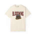 Officially licensed Bloodwing Academy Comfort Colors graphic tee by thtgrlreads featuring a vintage-style print with "Sangratha Bloodwing Academy" text and emblem on a cream unisex cotton shirt.