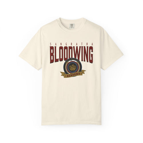 Officially licensed Bloodwing Academy Comfort Colors graphic tee by thtgrlreads featuring a vintage-style print with "Sangratha Bloodwing Academy" text and emblem on a cream unisex cotton shirt.