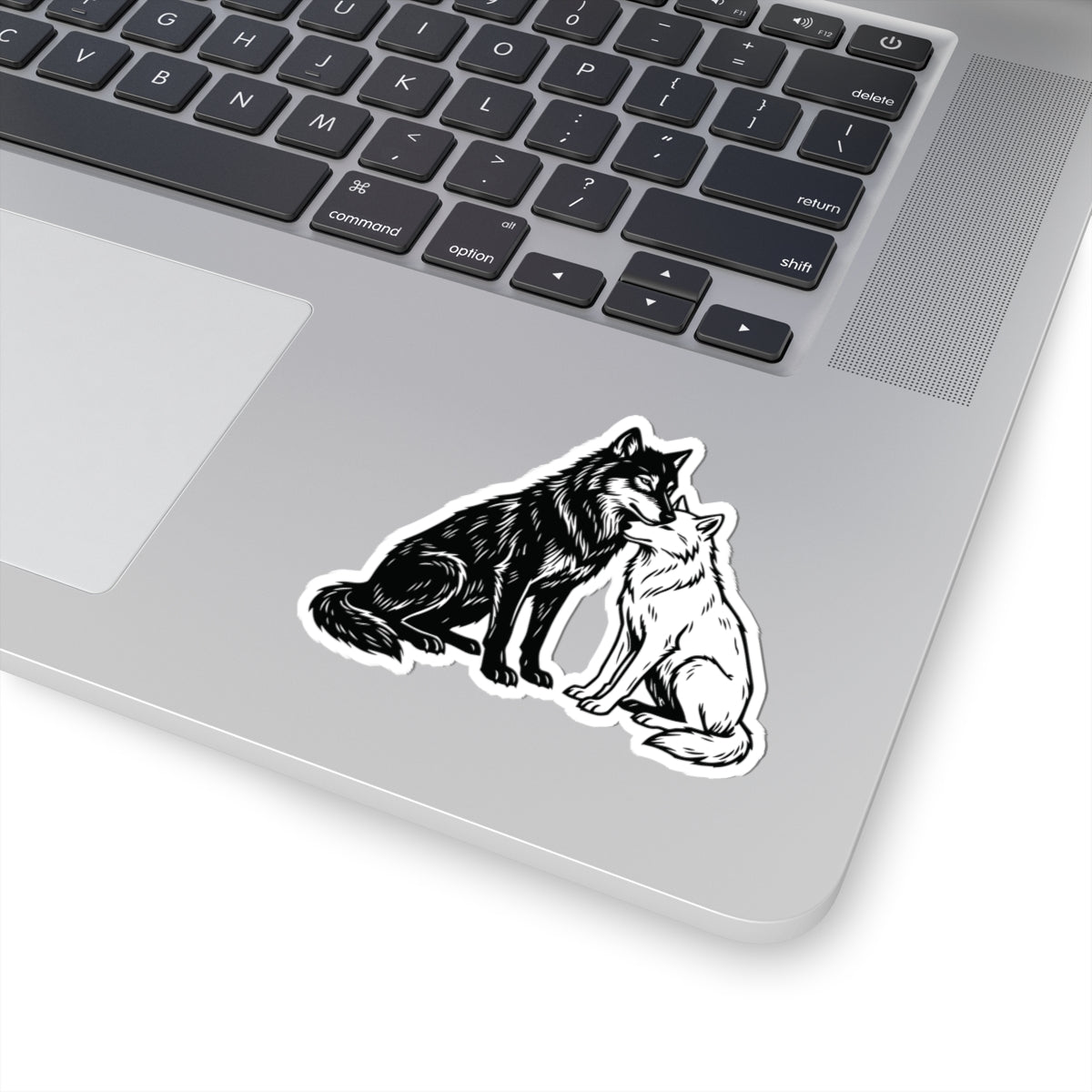 A Wolves of Ruin inspired Cratos & Anassa sticker from thtgrlreads, featuring detailed black and white wolves in an intimate pose, perfect for laptop decoration.
