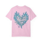 A Zodiac Academy comfort colors graphic tee from thtgrlreads in light pink featuring a vintage wash and a large vintage puff print graphic of a blue flaming heart with the phrase "Blue means you" in retro script font.