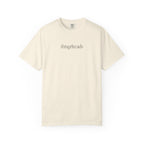 Thtgrlreads bookish apparel featuring a vintage wash Comfort Colors cream graphic tee with minimalist black serif text "thisgrlreads," part of the Tees and Book Bestie collections.