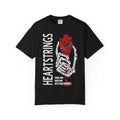 A black Comfort Colors graphic tee from thtgrlreads featuring Liv Zander-inspired design with a skeletal hand holding a detailed red anatomical heart and bold vertical "Heartstrings" text, perfect for romantasy fans in the Tees collection.
