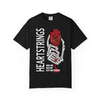 A black Comfort Colors graphic tee from thtgrlreads featuring Liv Zander-inspired design with a skeletal hand holding a detailed red anatomical heart and bold vertical "Heartstrings" text, perfect for romantasy fans in the Tees collection.