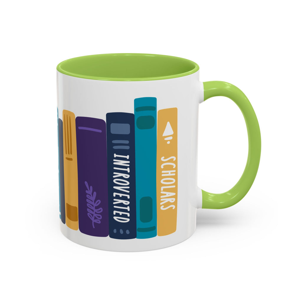 A white ceramic mug with a green handle and interior featuring a colorful graphic of vertically arranged books labeled "INTROVERTED" and "SCHOLARS" in a simple, modern illustration style.