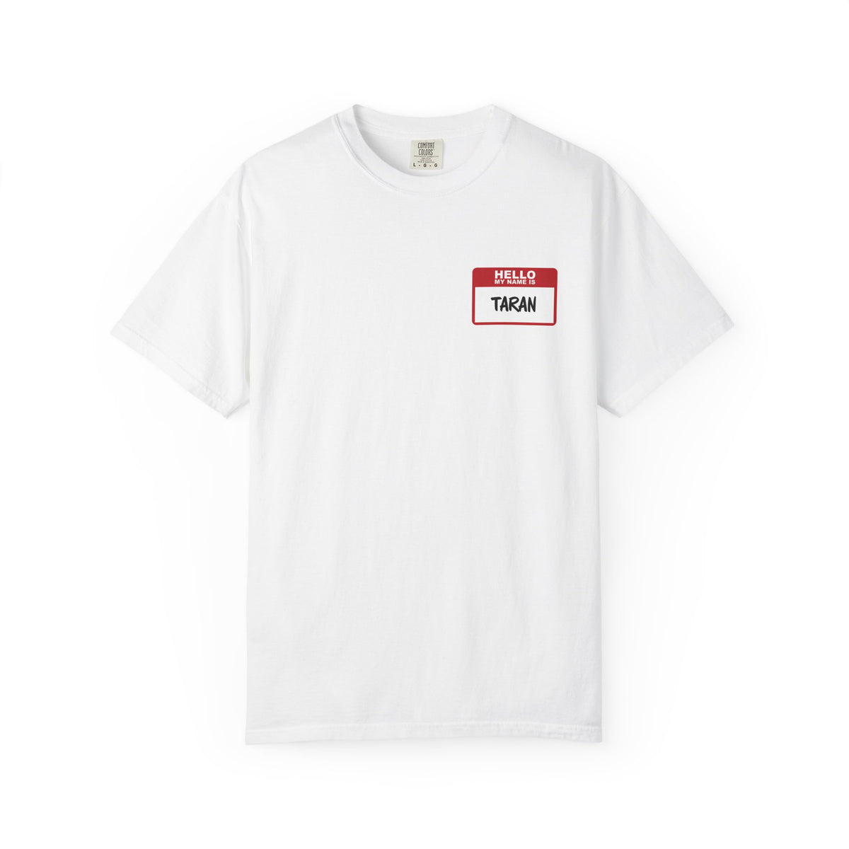 A white Comfort Colors graphic tee from thtgrlreads featuring a vintage wash and a red and white "Hello My Name Is TARAN" name tag print, part of the Kindred's Curse Saga collection.