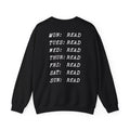 Thtgrlreads book bestie collection oversized crewneck sweatshirt in vintage black with white text listing each day of the week paired with "READ" in a bold typewriter font, cozy unisex fit from comfort colors.