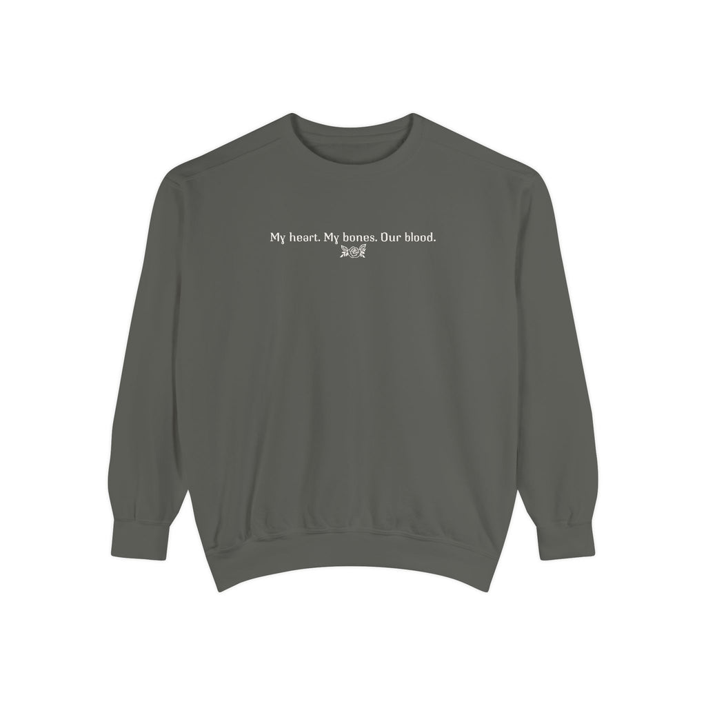 The Poison Daughter collection cozy crewneck sweatshirt by thtgrlreads in vintage-washed comfort colors fabric, featuring white minimalist text "My heart. My bones. Our blood." across the chest.