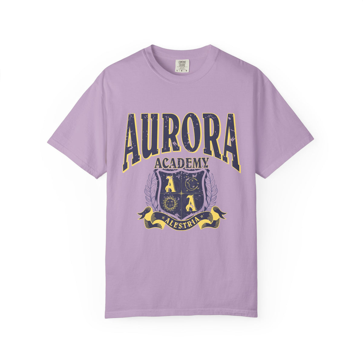 A vintage wash lilac Comfort Colors graphic tee from thtgrlreads featuring a distressed print of Aurora Academy with a crest emblem, part of the Ruthless Boys of the Zodiac and Back to School collections.
