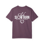 Officially licensed Club Slow Burn tee from thtgrlreads, featuring a premium Comfort Colors vintage-washed graphic tee with bold white text and a flaming heart design, part of the Book Bestie collection.