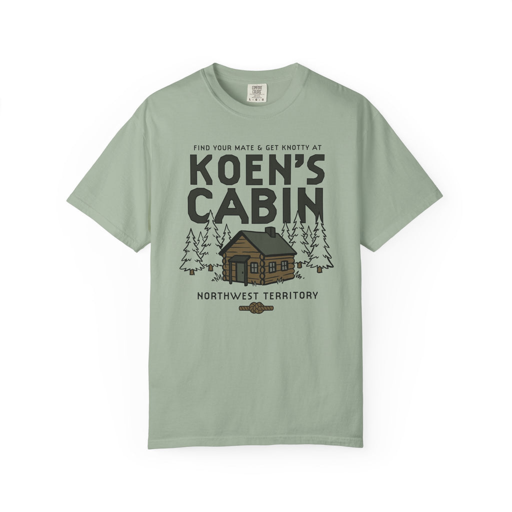 Sage green Comfort Colors graphic tee featuring a cabin, pine trees, and Koen's Cabin design from Ali Hazelwood, by Thtgrlreads, in Tees and Ali Hazelwood.