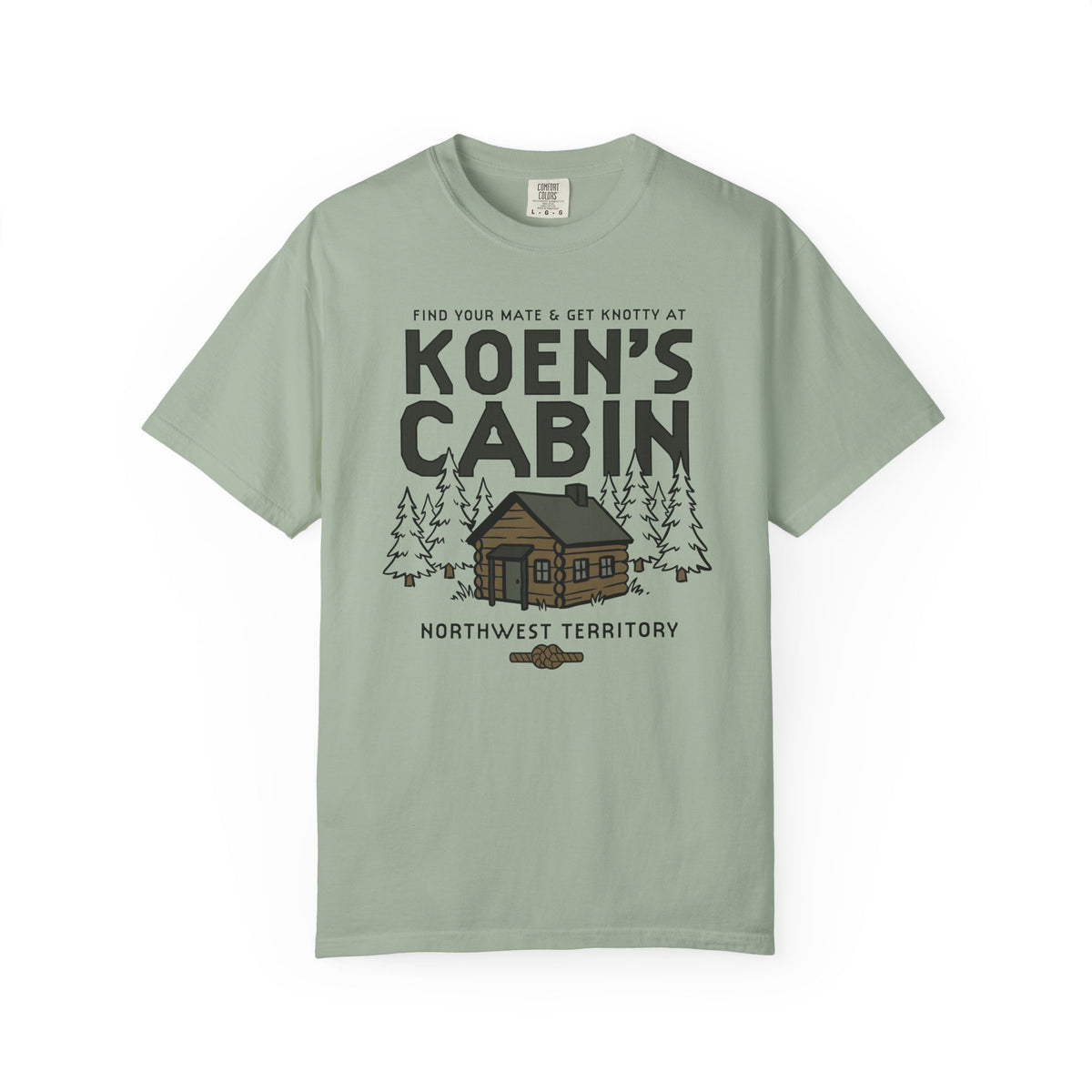 Sage green Comfort Colors graphic tee featuring a cabin, pine trees, and Koen's Cabin design from Ali Hazelwood, by Thtgrlreads, in Tees and Ali Hazelwood.