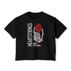Black cropped Comfort Colors t-shirt from thtgrlreads Liv Zander collection featuring a graphic of a skeletal hand holding an anatomical heart with the vertical text "HEARTSTRINGS" and smaller text "wed me bed me slit my throat" in bold style.