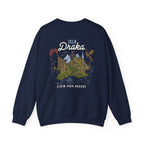 thtgrlreads Blood Bound collection navy oversized crewneck sweatshirt by Printify featuring a vintage graphic print of mountains and dragons with "Isla Draka" text, made from a soft Comfort Colors base.