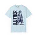 Kindred's Curse Saga tee by thtgrlreads featuring a vintage wash Comfort Colors graphic tee in light blue with bold black print of a fantasy character and text "Luther Prince of Lumnos," part of official licensed bookish apparel collections.