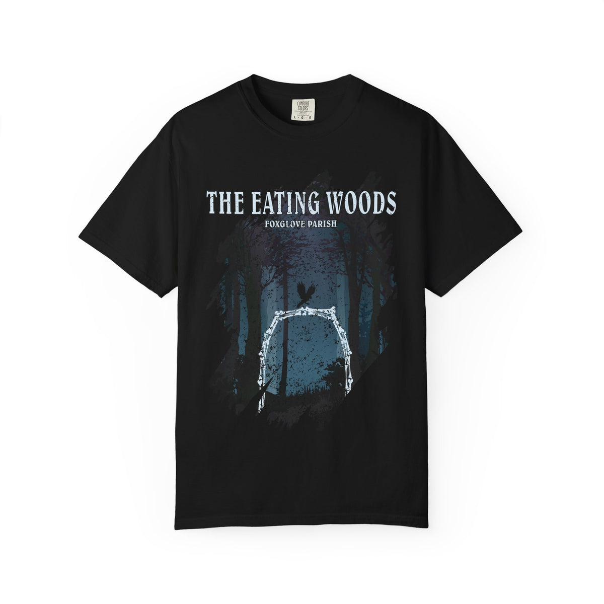 Thtgrlreads Comfort Colors graphic tee from The Eating Woods collection featuring a vintage wash black tee with a forest arch design and white text reading "The Eating Woods Foxglove Parish.