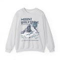 Thtgrlreads Wolves of Ruin collection vintage-wash Comfort Colors crewneck sweatshirt featuring a bold Mount Wolfsbane mountain graphic with moonlit night theme and stylized text.