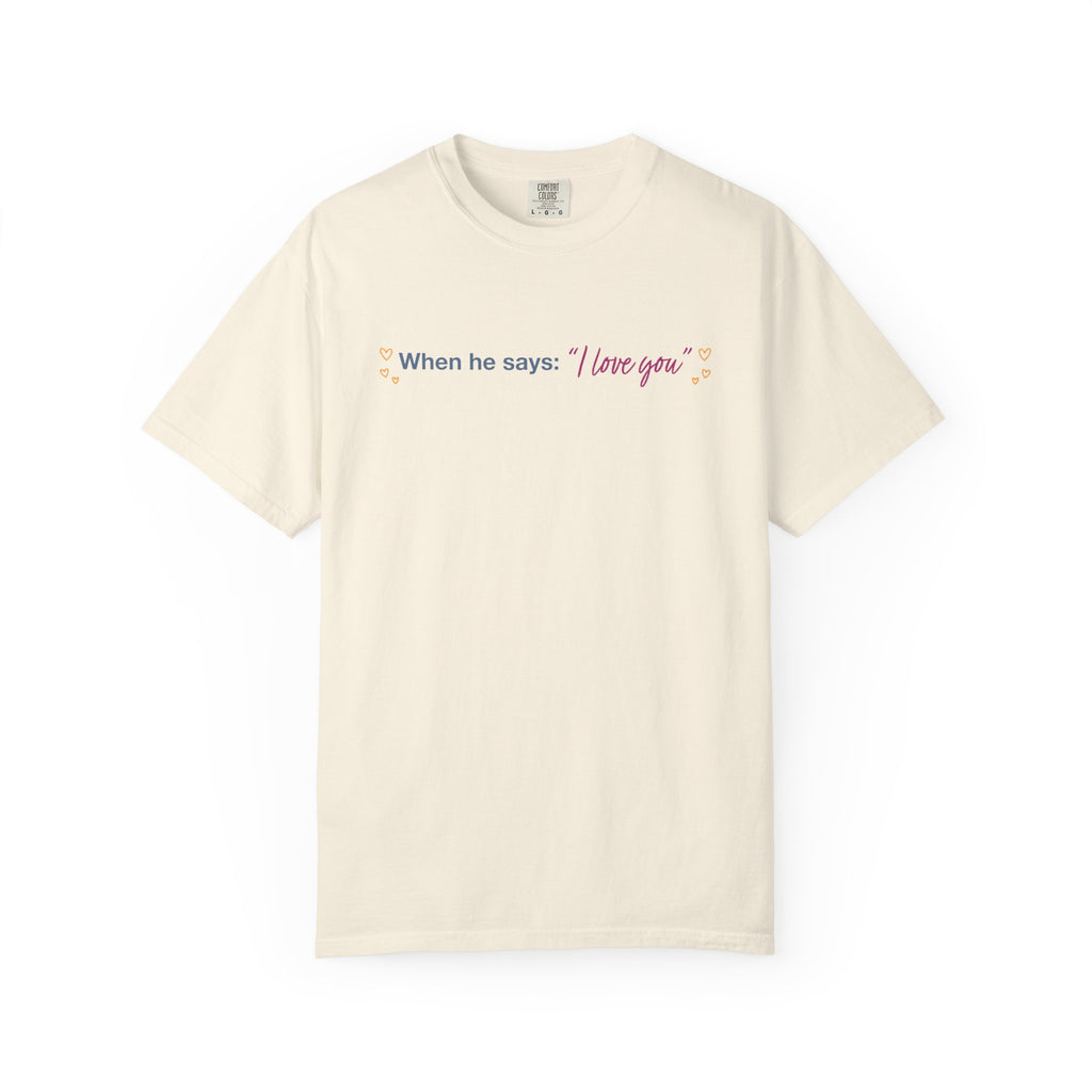 Cream Comfort Colors graphic tee featuring the quote When he says I love you with delicate floral accents, inspired by Ali Hazelwoods Love Theoretically from Thtgrlreads