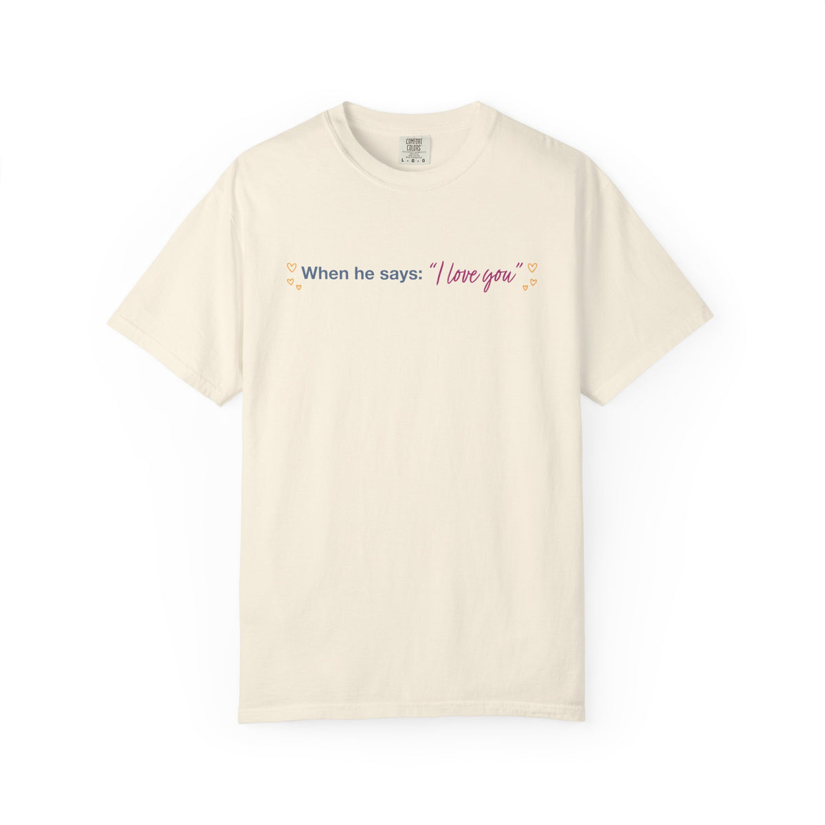 Cream Comfort Colors graphic tee featuring the quote When he says I love you with delicate floral accents, inspired by Ali Hazelwoods Love Theoretically from Thtgrlreads