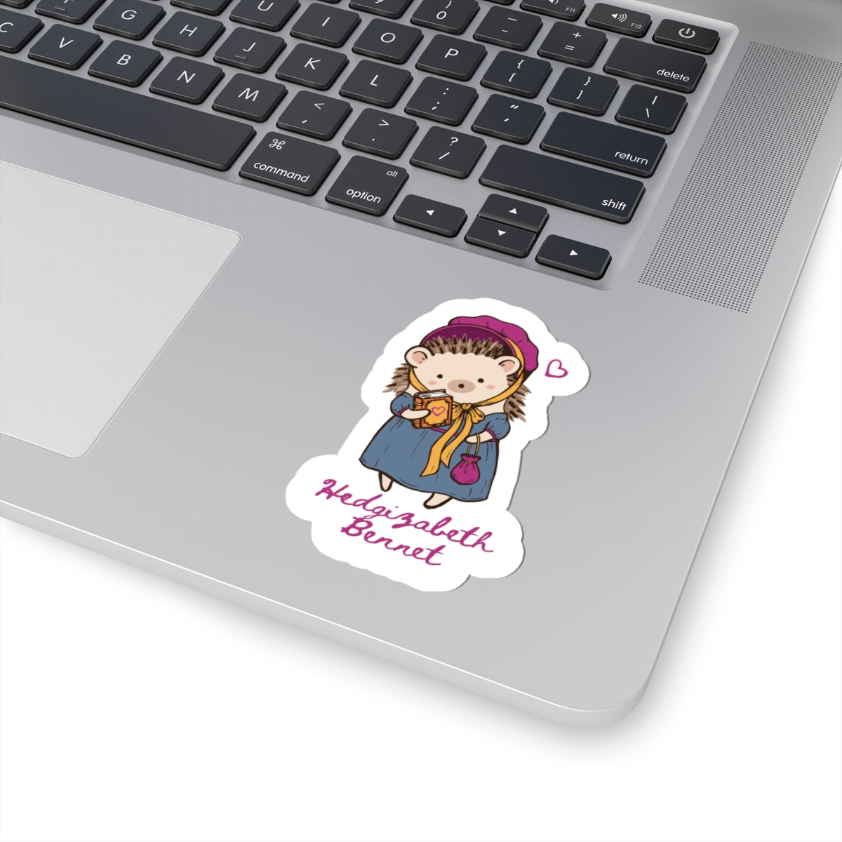 Hedgizabeth Bennet illustrated vinyl sticker featuring a hedgehog in period attire with a teacup, displayed on a laptop by Thtgrlreads for Ali Hazelwood fans.