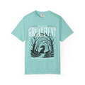 A vintage wash Comfort Colors graphic tee from thtgrlreads featuring a dark fantasy design of a silhouetted figure within twisted trees and text reading "Welcome to The Great Hunt," part of the Tees and Hollow collections.