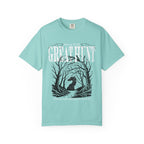 A vintage wash Comfort Colors graphic tee from thtgrlreads featuring a dark fantasy design of a silhouetted figure within twisted trees and text reading "Welcome to The Great Hunt," part of the Tees and Hollow collections.