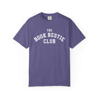 Comfort Colors graphic tee in vintage purple with white collegiate-style text reading "The Book Bestie Club," officially licensed by thtgrlreads from the Book Bestie collection.