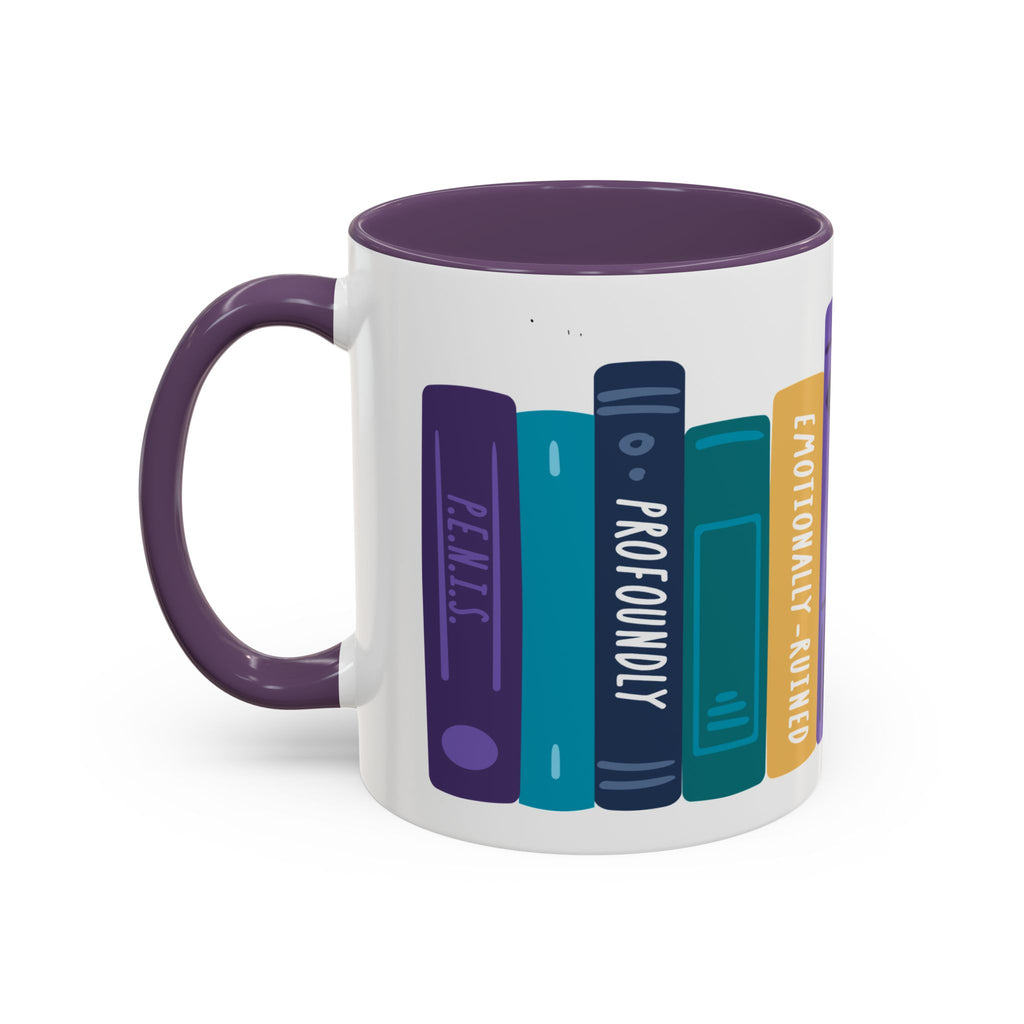 A white ceramic book-themed mug with a dark purple handle and rim, featuring colorful illustrated book spines with playful titles, from thtgrlreads.