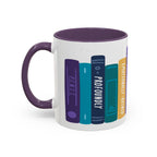 A white ceramic book-themed mug with a dark purple handle and rim, featuring colorful illustrated book spines with playful titles, from thtgrlreads.