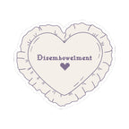 A heart-shaped embroidered sticker from thtgrlreads inspired by The Poison Daughter collection, featuring purple cross-stitch text "Disembowelment" with a small heart below.