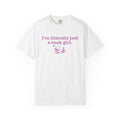 White Comfort Colors graphic tee from thtgrlreads featuring a pastel pink text and illustration design reading "I'm literally just a book girl" with a cat on stacked books, part of the Tees and Book Bestie collections.