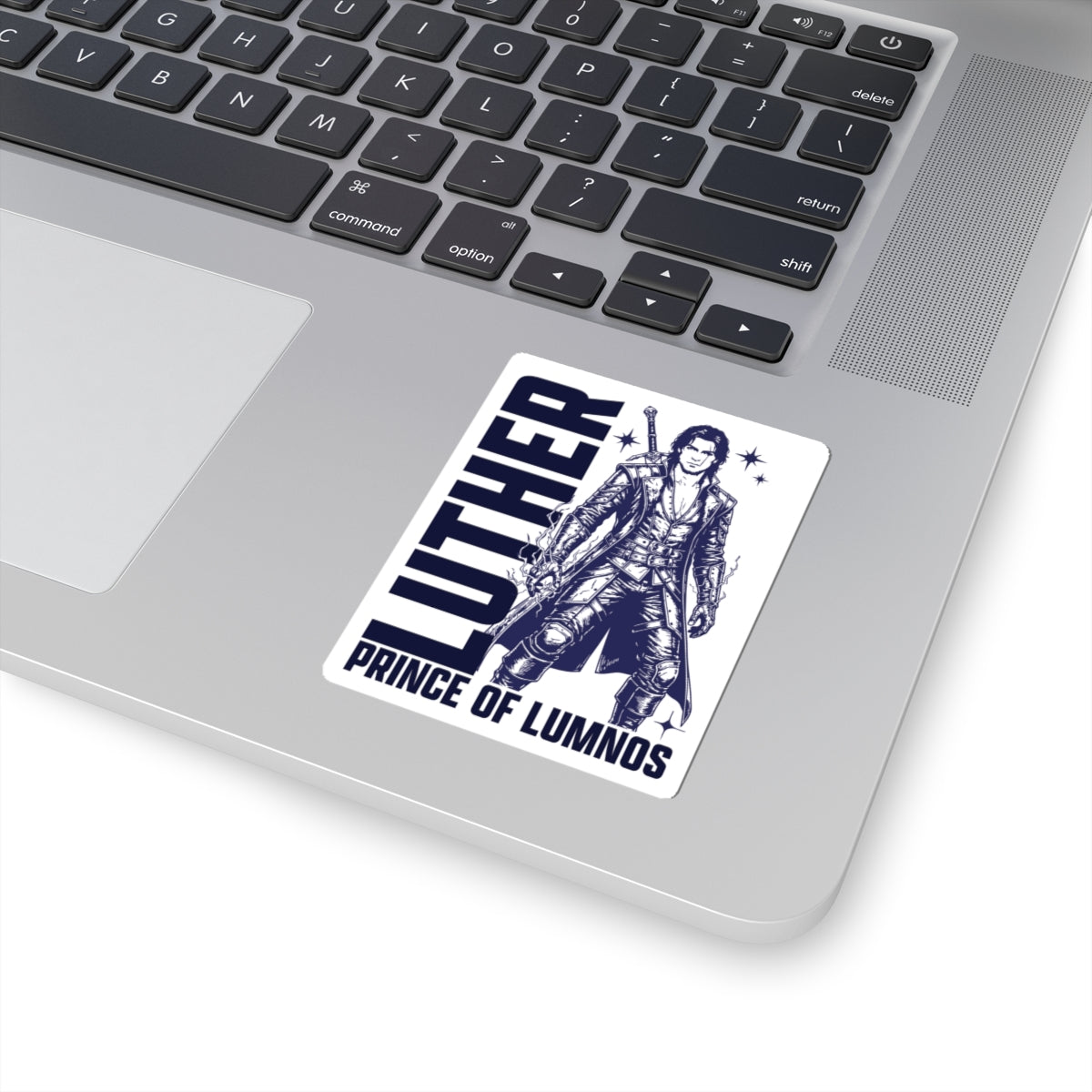 Sticker from Thtgrlreads featuring a detailed black-and-white illustration of Luther, Prince of Lumnos, part of the Kindred's Curse Saga collection, placed on a laptop corner.