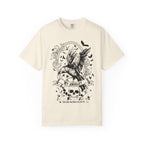 A vintage-wash comfort colors graphic tee from thtgrlreads featuring Liv Zander-inspired fantasy artwork with a detailed black crow, skulls, and gothic script, part of the Liv Zander and Tees collections.