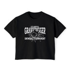 A black vintage-wash Comfort Colors crop top from thtgrlreads featuring a bold white graphic with "1st Annual Gravedigger Snowball Tournament" text and a snowball design, part of the Liv Zander collection.