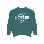 A vintage-washed Comfort Colors oversized crewneck sweatshirt in teal featuring white graphic text "Club Slow Burn" and a heart design, officially licensed by thtgrlreads, perfect for Book Bestie and Crewnecks collections.