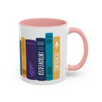 White ceramic mug with pink handle and interior featuring colorful illustrated book spines labeled "Introverted" and "Scholars," designed by thtgrlreads for book lovers.