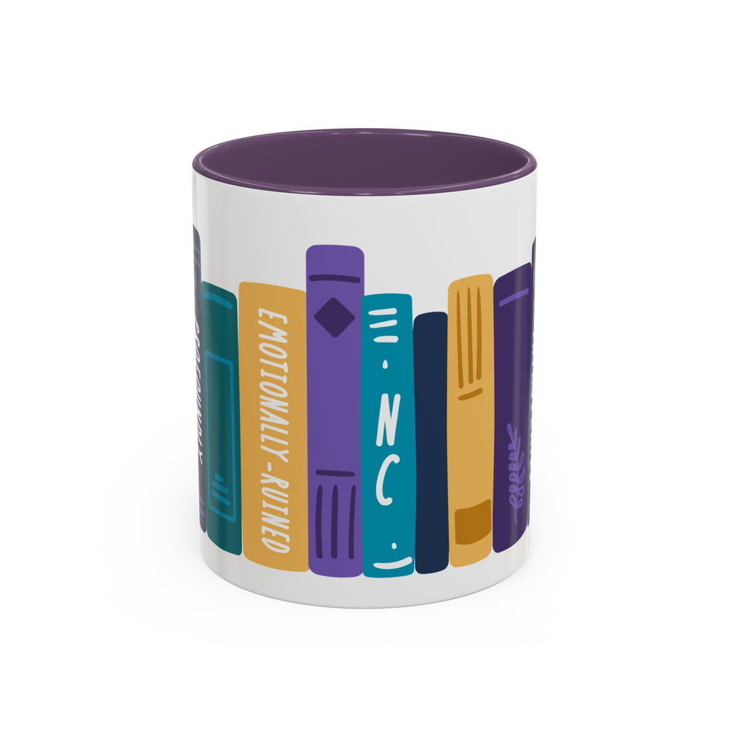 White ceramic mug with a purple interior featuring a colorful graphic of upright books with titles like "Emotionally-Ruined" in a bold, blocky illustration style.