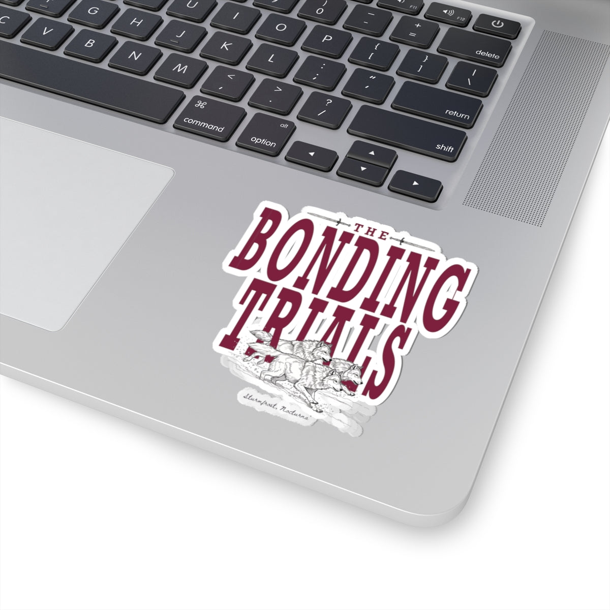 Sticker from thtgrlreads featuring Wolves of Ruin collection design with bold maroon lettering reading "The Bonding Trials" over an illustrated wolf pack, perfect for bookish fans.
