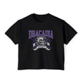 Nocticadia-themed crop top from thtgrlreads featuring vintage wash black Comfort Colors fabric with purple collegiate-style "Dracadia" text and skull graphic emblem, part of official licensed Tees collections.