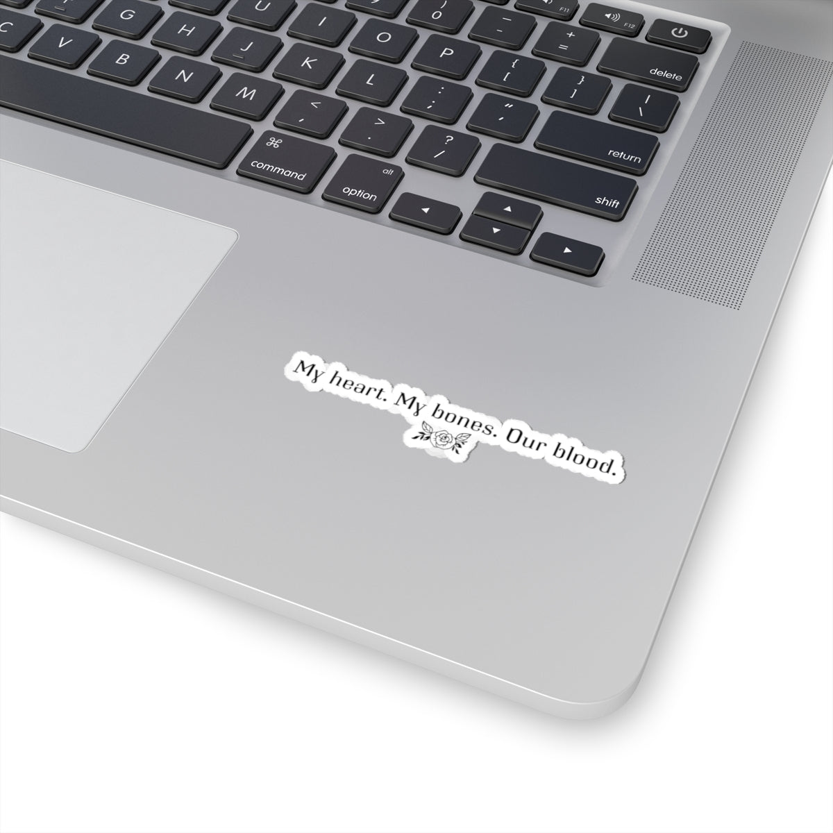 Sticker from thtgrlreads inspired by The Poison Daughter collection, featuring a monochrome quote design "My heart. My bones. Our blood." with small floral accents, perfect for laptops or notebooks.