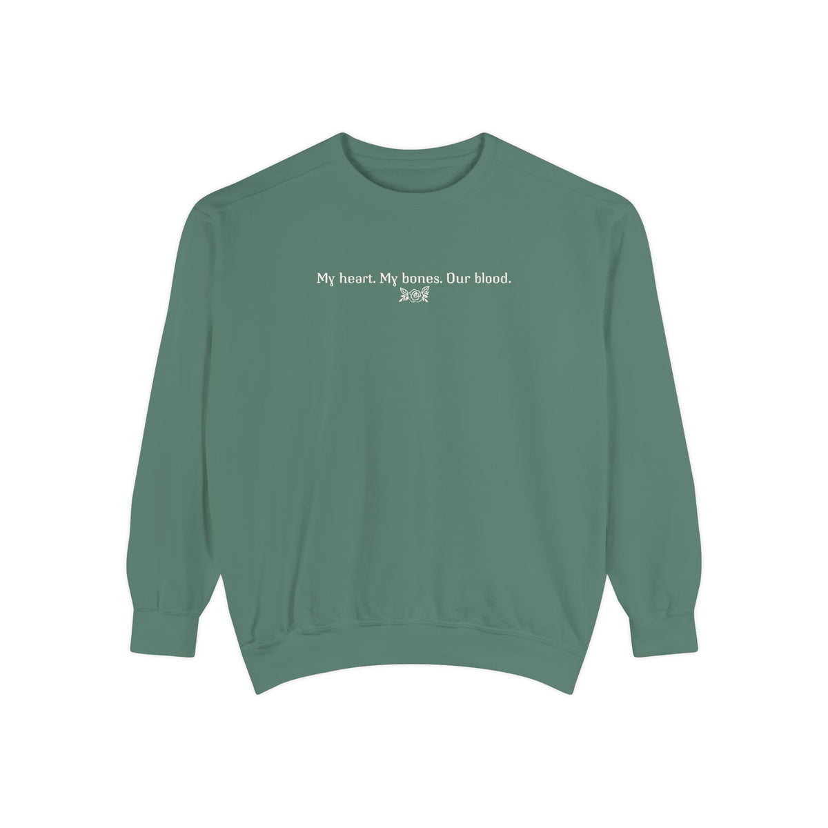 Thtgrlreads oversized crewneck from The Poison Daughter collection featuring a sage green vintage wash Comfort Colors base with white text reading "My heart. My bones. Our blood." in a simple font.
