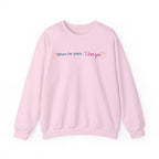 Pink crewneck sweatshirt featuring the quote When he says I love you with heart accents, Thtgrlreads Ali Hazelwood licensed bookish apparel.