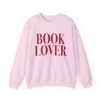 Thtgrlreads cozy Comfort Colors oversized crewneck from the Crewnecks collection features a vintage-washed soft pink fabric with bold red "BOOK LOVER" text, perfect for bookish apparel fans.
