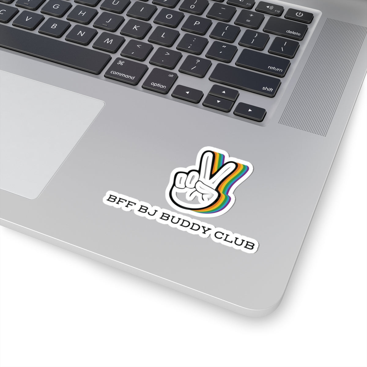 A laptop corner featuring a colorful outline peace hand gesture sticker with "BFF BJ BUDDY CLUB" text in bold black font beneath it.