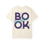 thtgrlreads Book Bestie collection comfort colors graphic tee with vintage washed cream fabric featuring bold navy "BOOK" lettering and teal cursive "bestie" overlay with star accents, unisex fit