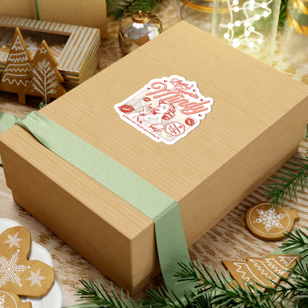 Sticker themed around Ruthless Boys of the Zodiac from thtgrlreads, featuring a vintage-style red illustration and lettering, displayed on a gift box with holiday decor accents.