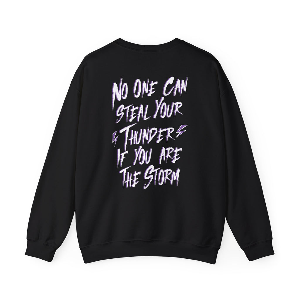 Thtgrlreads Lady of Darkness & Legacy Series oversized crewneck sweatshirt in black with bold white and purple graphic text reading "No one can steal your thunder if you are the storm" on the back, featuring a vintage-washed Comfort Colors base.