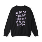 Thtgrlreads Lady of Darkness & Legacy Series oversized crewneck sweatshirt in black with bold white and purple graphic text reading "No one can steal your thunder if you are the storm" on the back, featuring a vintage-washed Comfort Colors base.